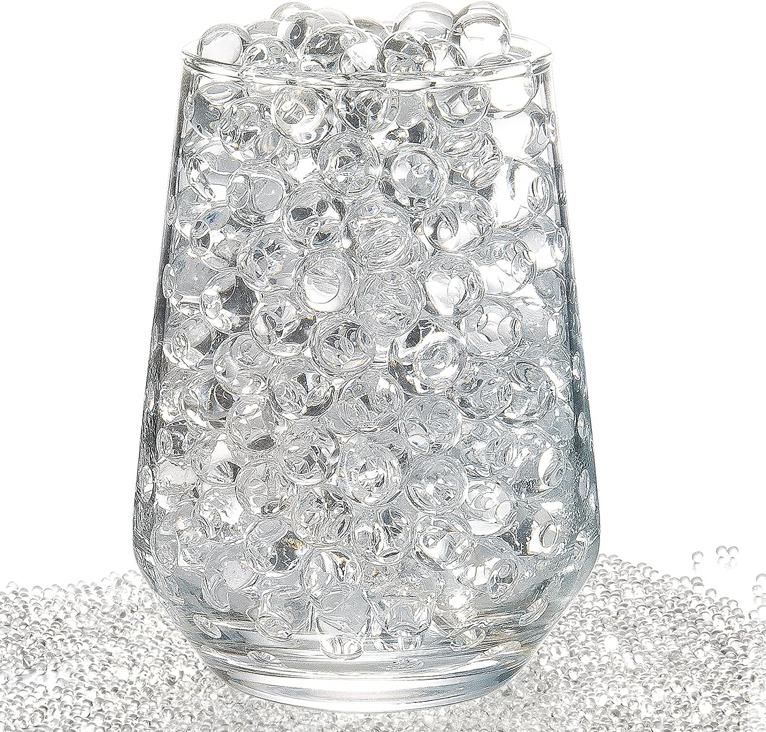Clear water gel jelly beads in a glass on a white background. Clear water gel jelly beads in a glass on a white background.